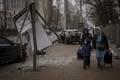 Women and a boy walk to the train station 