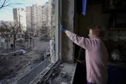 A woman measures a window