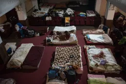  A woman sits on a makeshift bed
